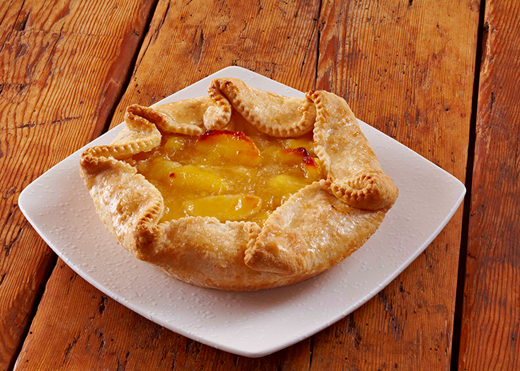 pocket pie filled with apple filling on a white plate