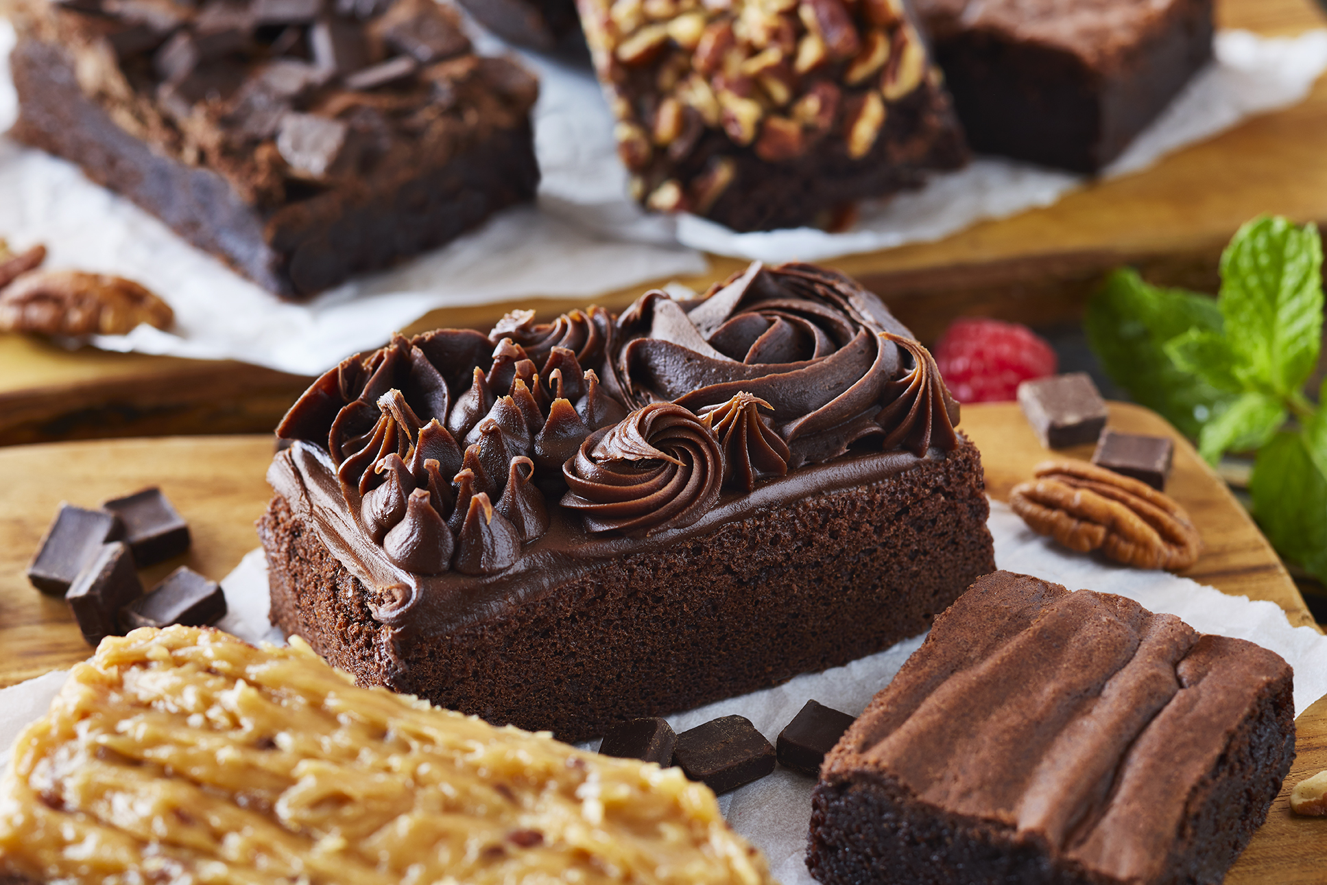 an assortment of brownies with chocolate icing