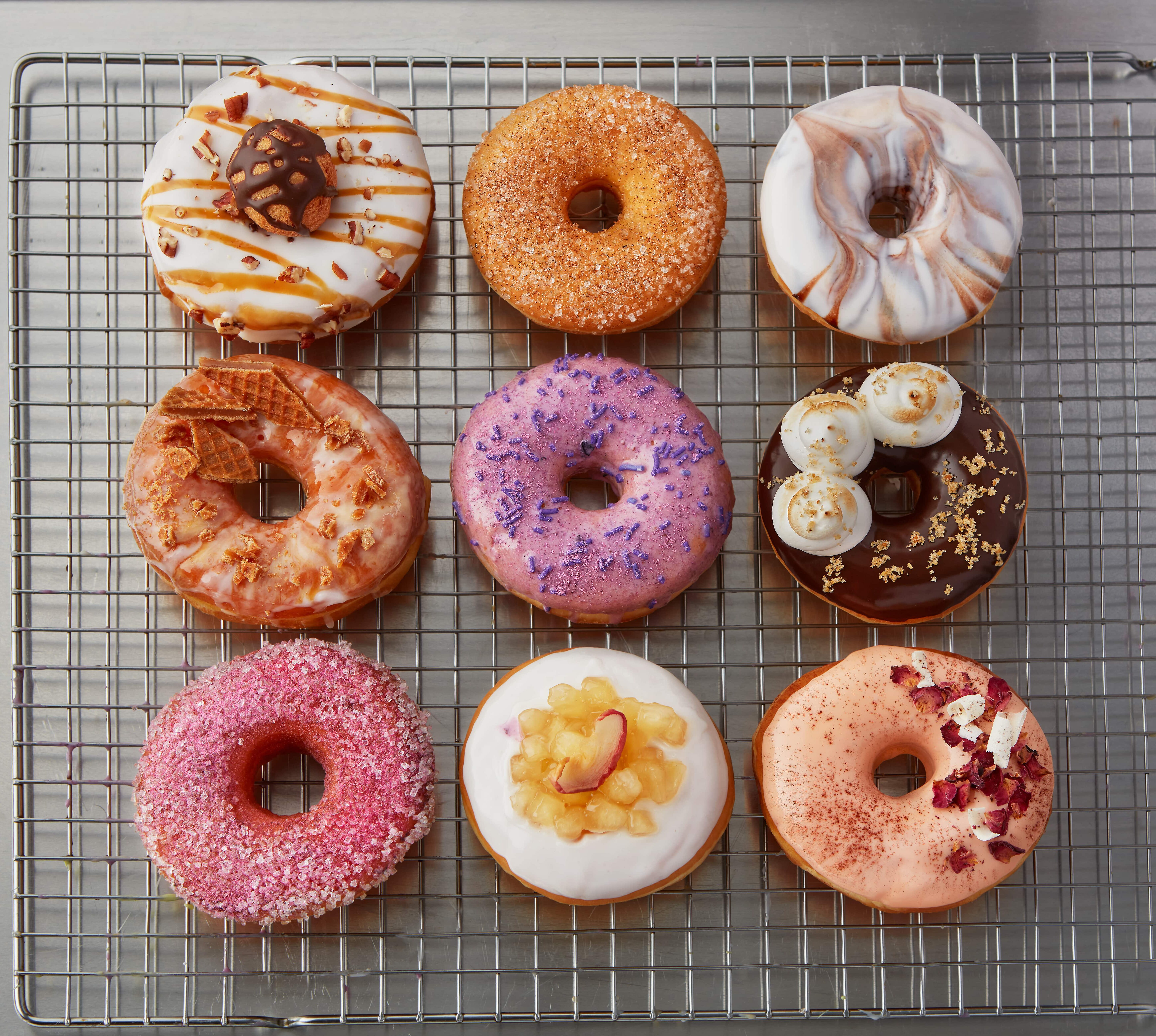 an overhead shot of an assortment of decorated yeast raised donuts