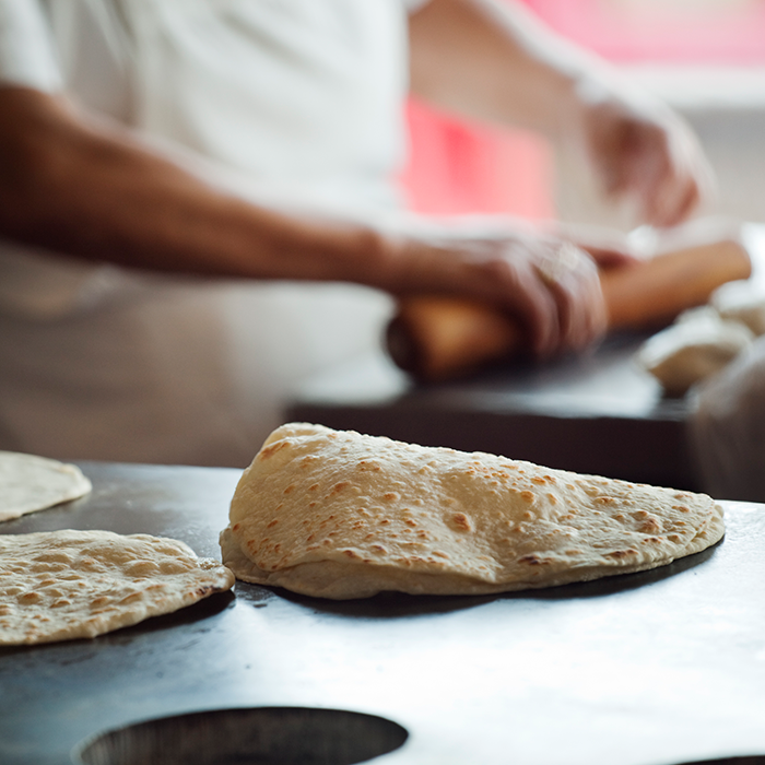 tortillas being cooked on a flat top