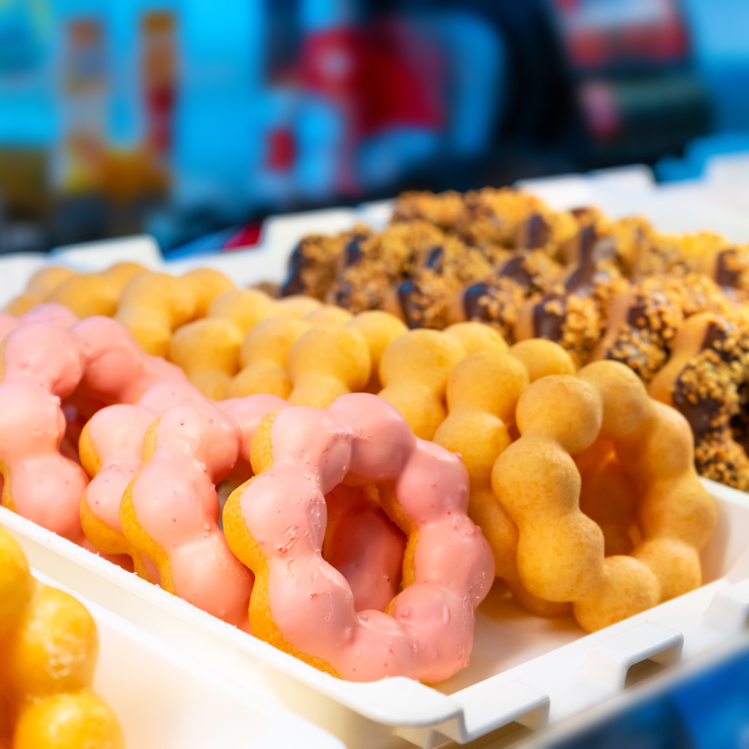 Assortment of mochi donuts on trays