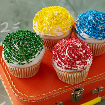 assorted cupcakes decorated with colorful sprinkles