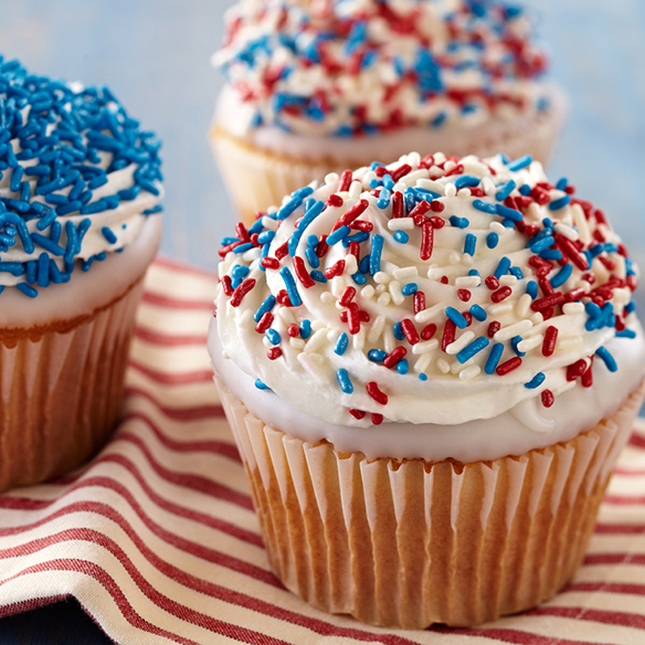 Three cupcakes decorated with red, white and blue sprinkles