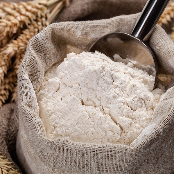 a bag of flour with a scoopa