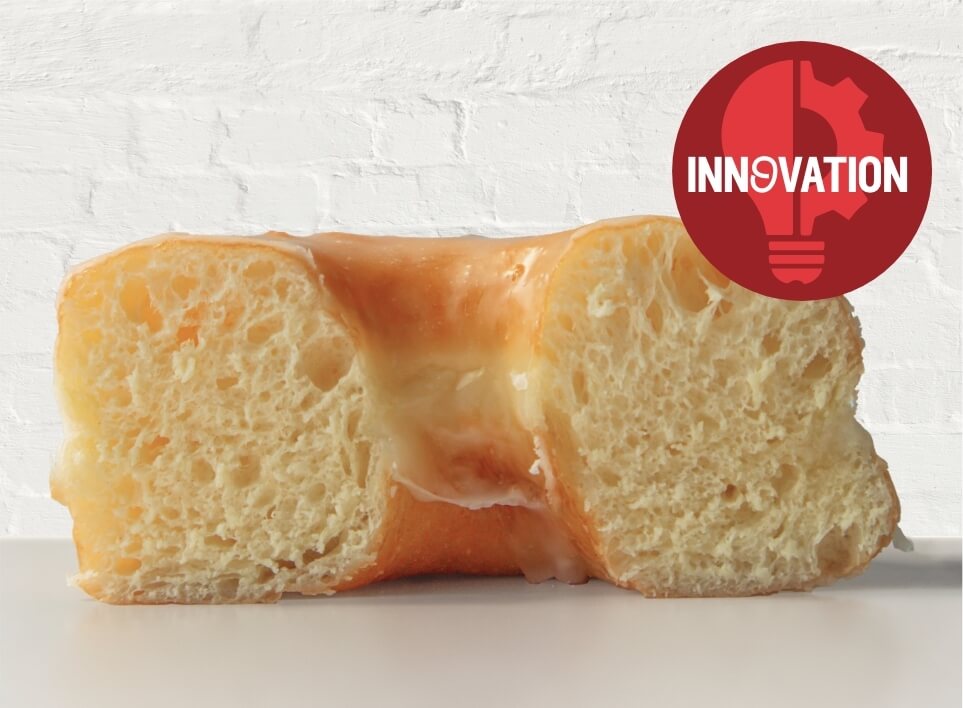 Text saying Innovation with an image of cross cut of a cake donut behind the text