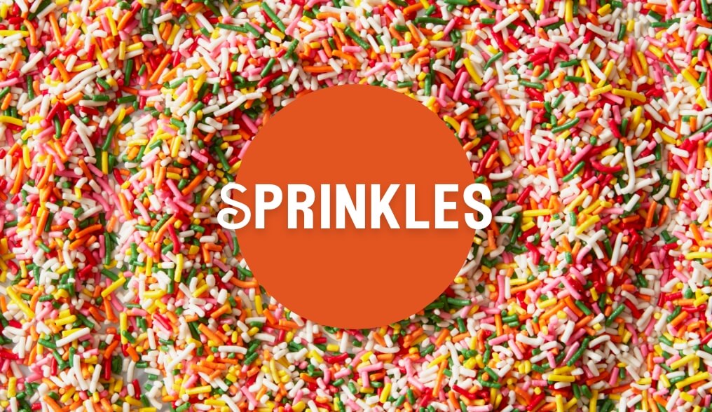 Text saying sprinkles with an image of a pile of multicolored sprinkles behind the text